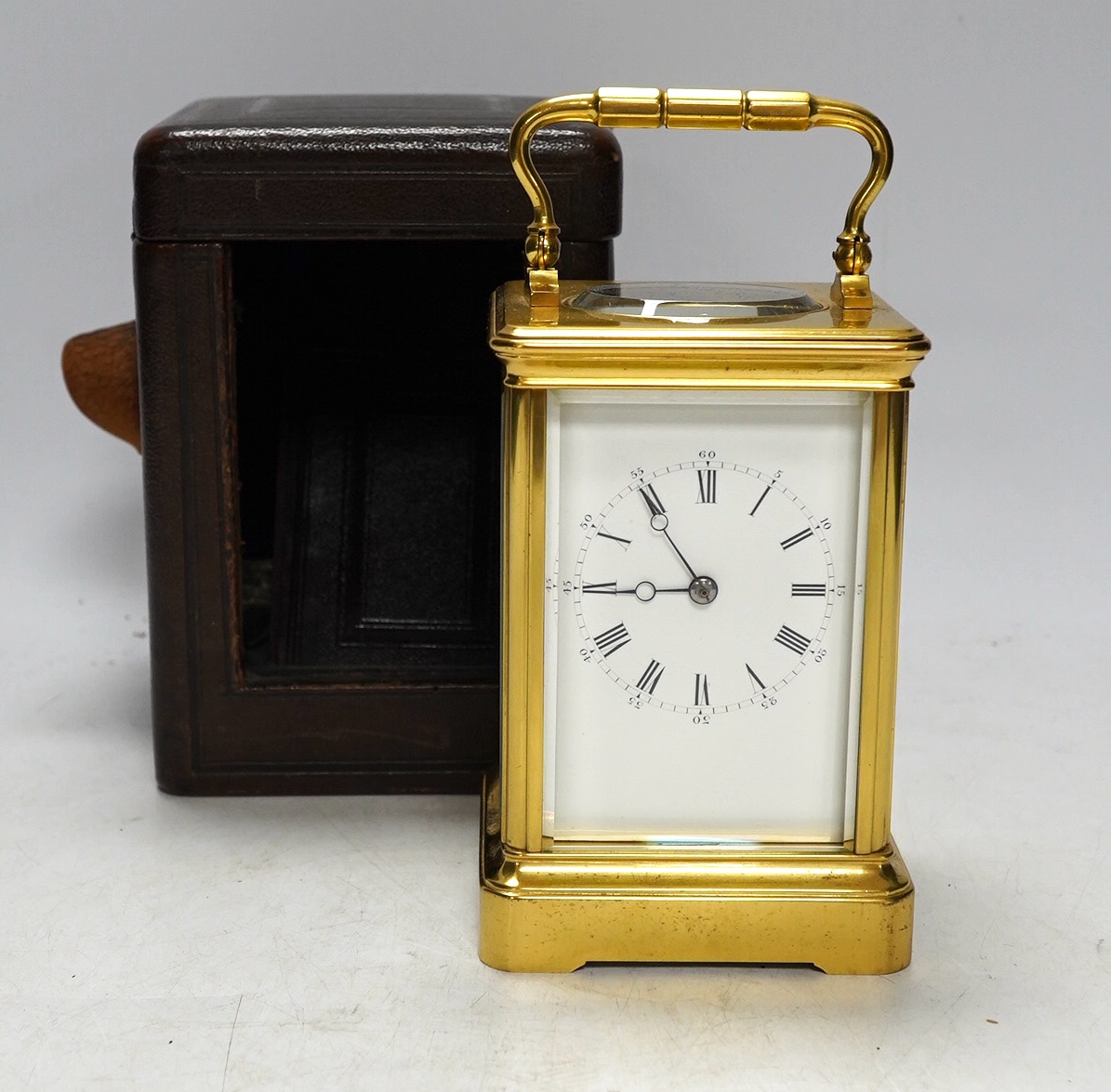 A cased unnamed brass carriage clock, 14cm tall. Condition - fair